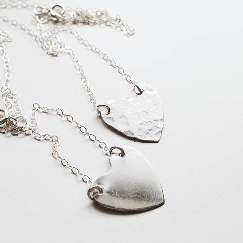 two silver hammered heart necklaces with chains