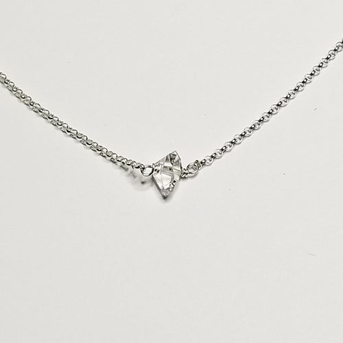 a herkimer diamond on a silver chain with a white background
