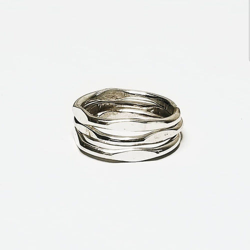 three simple silver rings stacked on a white background