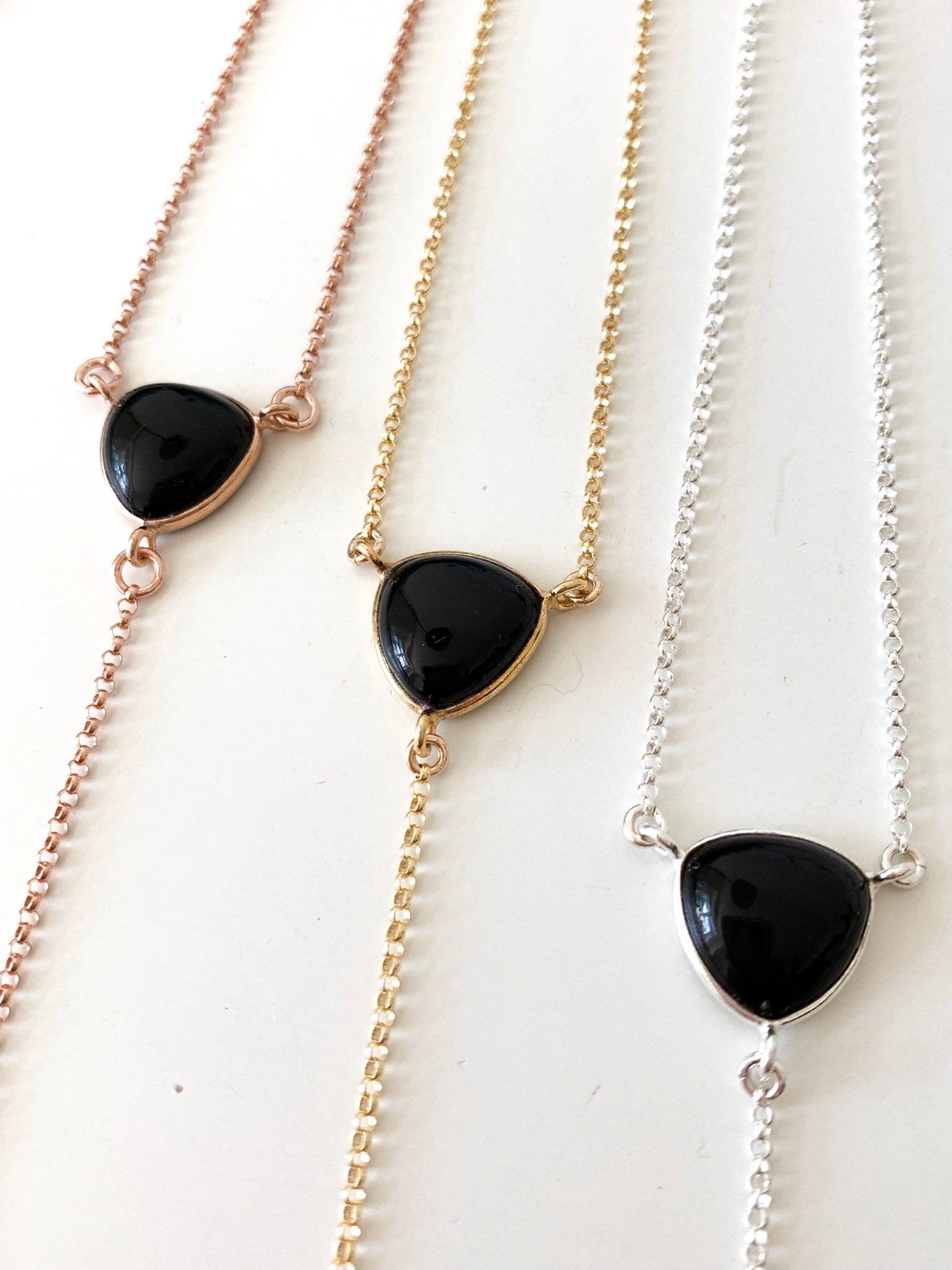 three black onyx stone lariats with rose gold, gold and silver chain options 